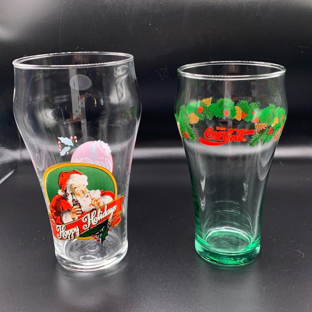 2 Coca-Cola Collectible Holiday Glasses. Santa and Pine, Holly, Pinecone garland
